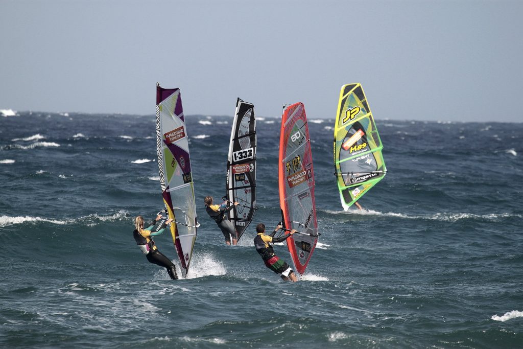A group of people windsurfing