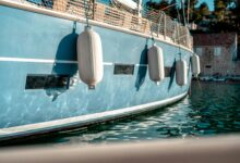 white fenders on a light blue boat