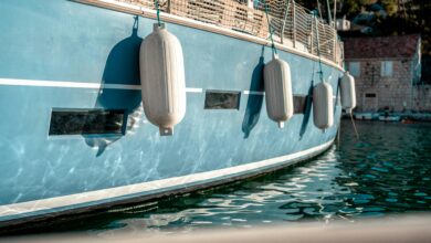 white fenders on a light blue boat