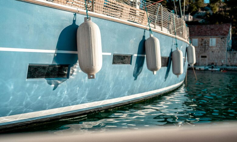 white fenders on a light blue boat